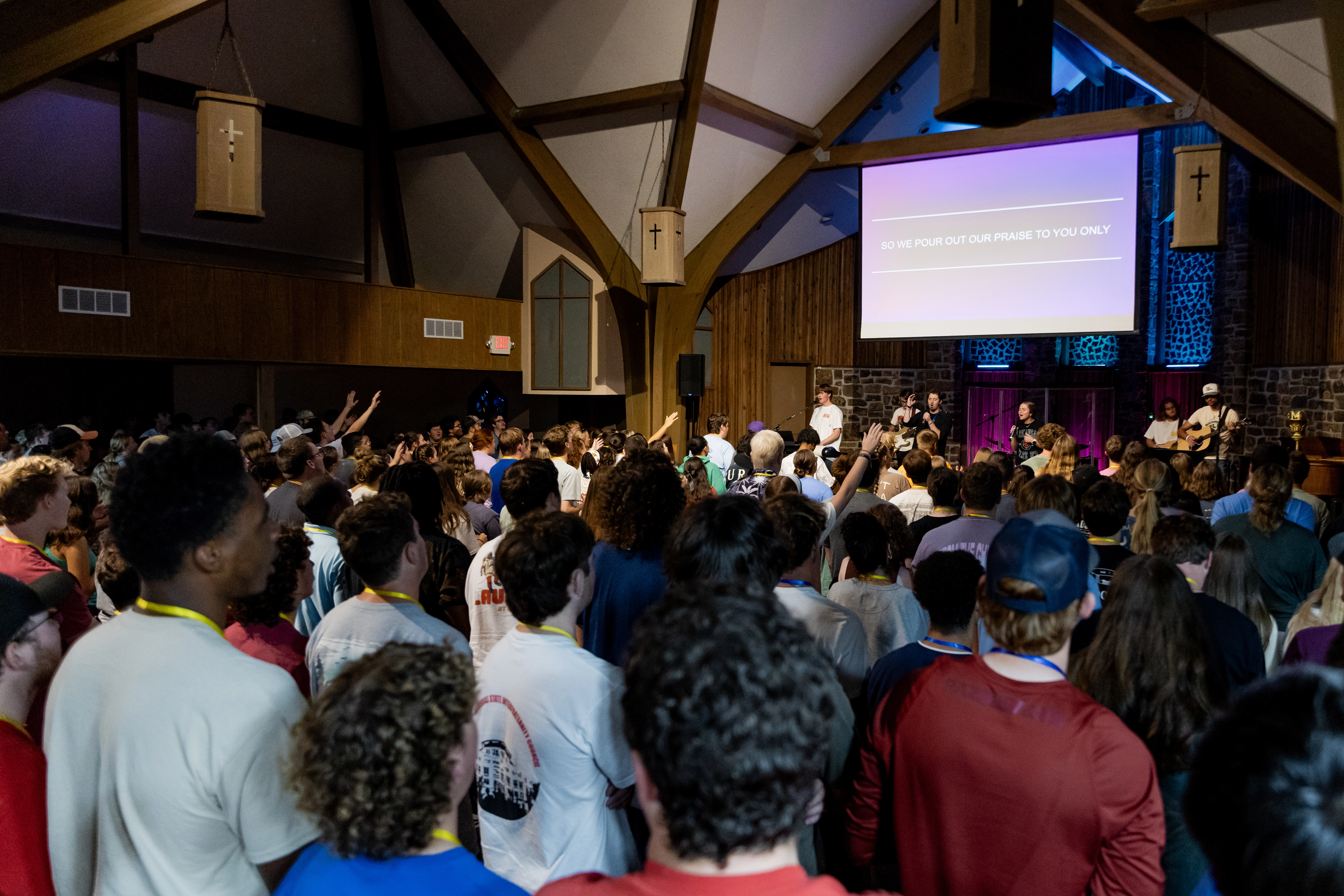 A Large Crowd of students worshiping in a chapel