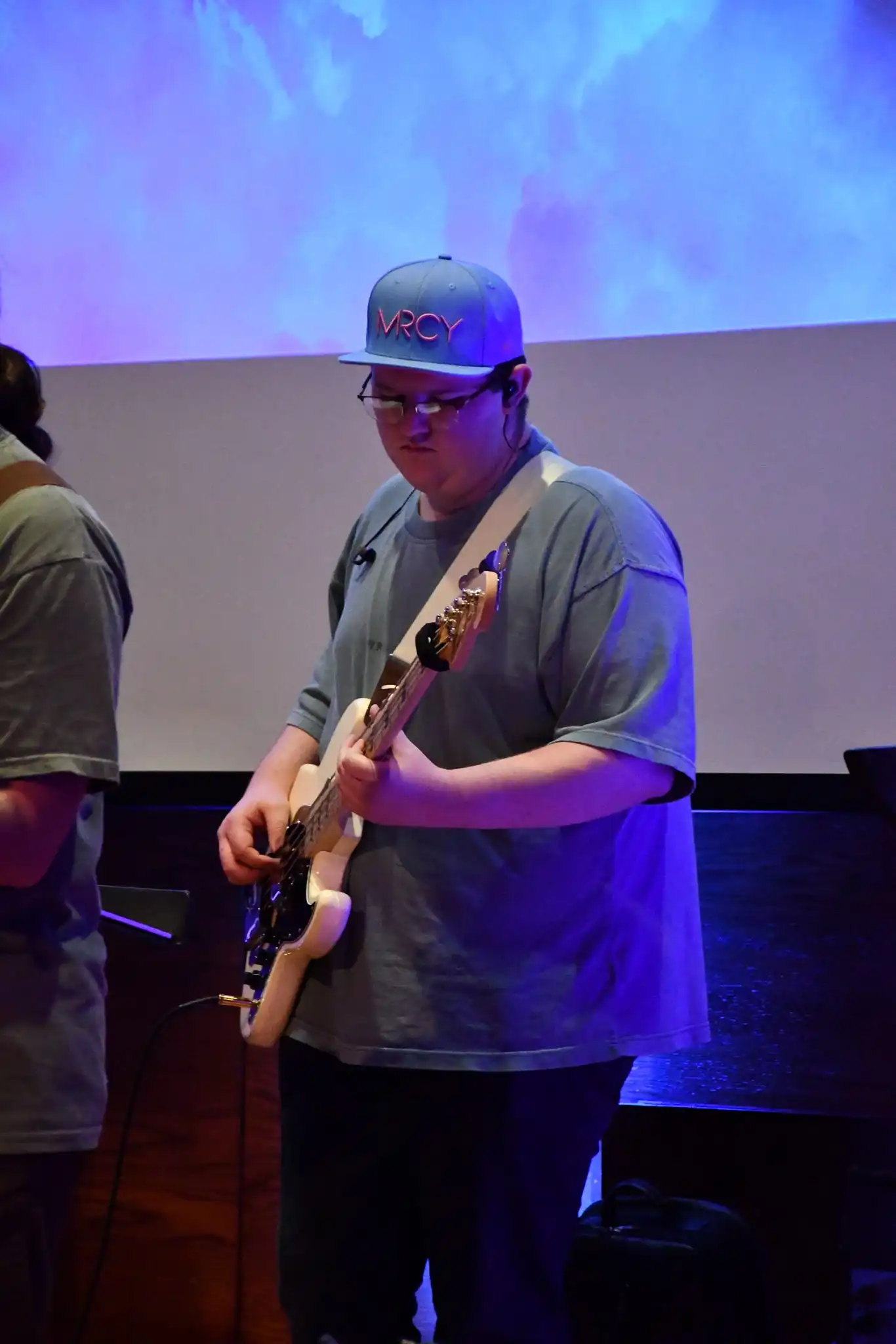 A man playing piano, a band behind him.